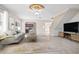 Bright living room features a beige sofa and a view into the kitchen at 2291 Henry Ln, Deltona, FL 32738