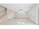 Bright living room featuring tile floors and a staircase at 2291 Henry Ln, Deltona, FL 32738