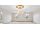 Spacious dining room with large windows and a chandelier at 2291 Henry Ln, Deltona, FL 32738