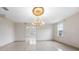 Formal dining room with a large chandelier and tile floors at 2291 Henry Ln, Deltona, FL 32738
