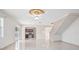 Open living room with tile floors, kitchen, and staircase views at 2291 Henry Ln, Deltona, FL 32738