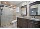 Elegant bathroom with granite countertops, dark wood cabinetry, and a walk-in shower at 2291 Henry Ln, Deltona, FL 32738