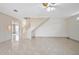 Spacious living area with tile floors and a view of the staircase at 2291 Henry Ln, Deltona, FL 32738
