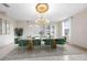 Elegant dining room with a large chandelier and green velvet chairs at 2291 Henry Ln, Deltona, FL 32738