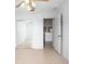 Bright bedroom features mirrored closet doors and neutral colored tile flooring at 2291 Henry Ln, Deltona, FL 32738
