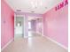 Youthful bedroom with pink walls, mirrored closet doors, and a chandelier at 2291 Henry Ln, Deltona, FL 32738