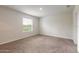 Spacious bedroom with neutral walls, carpeted floor, and large window at 1631 Primo Ct, Holly Hill, FL 32117