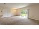 Bright living room with carpeted floors and sliding glass doors leading to backyard at 1631 Primo Ct, Holly Hill, FL 32117
