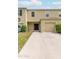 Townhouse exterior with two-car garage and driveway at 1631 Primo Ct, Holly Hill, FL 32117