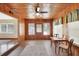 Bright sunroom with wood paneling, large windows, and a small table with chairs at 1402 Talton Ave, Deland, FL 32720