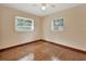 Simple bedroom with hardwood floors and two windows at 1402 Talton Ave, Deland, FL 32720