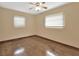 Spacious bedroom featuring hardwood floors and two windows at 1402 Talton Ave, Deland, FL 32720