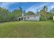 Single-story house with a carport, green lawn, and mature trees at 1402 Talton Ave, Deland, FL 32720