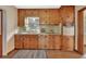 Kitchen with wood cabinets, double sink and built-in oven at 1402 Talton Ave, Deland, FL 32720