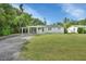 Ranch style home with carport and well-maintained lawn at 1402 Talton Ave, Deland, FL 32720