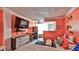 Studio apartment with coral walls, living area, and kitchenette at 935 S Atlantic Ave # 206, Daytona Beach, FL 32118