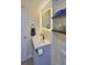 Bathroom features a vanity with a modern sink, lighted mirror, and shelving at 935 S Atlantic Ave # 206, Daytona Beach, FL 32118