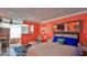 Bright bedroom with coral walls, comfy bed, and coastal decor at 935 S Atlantic Ave # 206, Daytona Beach, FL 32118