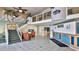 Welcoming lobby with tropical mural, seating area, and staircase to upper level at 935 S Atlantic Ave # 206, Daytona Beach, FL 32118