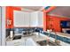 Bright kitchen features white cabinets, a blue tile backsplash, and a breakfast bar at 935 S Atlantic Ave # 206, Daytona Beach, FL 32118