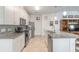 Modern kitchen with white cabinets, granite counters, and stainless steel appliances at 623 Margaritaville Ave, Daytona Beach, FL 32124