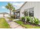 Side view of home with lush landscaping and screened porch at 623 Margaritaville Ave, Daytona Beach, FL 32124
