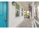 Front porch with teal door and brick pavers at 623 Margaritaville Ave, Daytona Beach, FL 32124