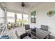 Relaxing screened porch with patio furniture, offering an outdoor dining space at 623 Margaritaville Ave, Daytona Beach, FL 32124