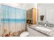 Bathroom with granite vanity, shower/tub combo, and beach-themed decor at 623 Margaritaville Ave, Daytona Beach, FL 32124