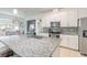 Modern kitchen with white cabinets, granite counters, and island at 623 Margaritaville Ave, Daytona Beach, FL 32124