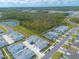 Aerial view of a neighborhood with houses, pond, and green space at 623 Margaritaville Ave, Daytona Beach, FL 32124