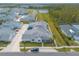 Aerial view of a house and neighborhood with pond and lush landscaping at 623 Margaritaville Ave, Daytona Beach, FL 32124