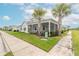 White home with teal accents and screened porch at 623 Margaritaville Ave, Daytona Beach, FL 32124