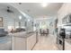 Open kitchen with island, granite counters, and stainless steel appliances at 623 Margaritaville Ave, Daytona Beach, FL 32124