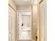Clean bathroom with a bathtub, tiled floors, and a view into a hallway at 1 John Anderson Dr # 1070, Ormond Beach, FL 32176