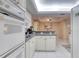 Modern kitchen with white cabinets, granite counters, and a breakfast bar at 1 John Anderson Dr # 1070, Ormond Beach, FL 32176