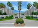 Elegant building exterior, featuring palm trees and a grand entrance at 1 John Anderson Dr # 1070, Ormond Beach, FL 32176