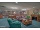 Cozy library with comfortable seating, a fireplace, and extensive bookshelves at 1 John Anderson Dr # 1070, Ormond Beach, FL 32176
