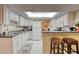 Bright kitchen with white cabinets, granite counters, and modern appliances at 1 John Anderson Dr # 1070, Ormond Beach, FL 32176
