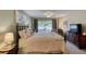 Bright bedroom featuring a large bed, dresser, and access to a private balcony at 1 John Anderson Dr # 1070, Ormond Beach, FL 32176