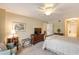 Relaxing bedroom with a comfortable bed, a sitting area, and ensuite bathroom access at 1 John Anderson Dr # 1070, Ormond Beach, FL 32176