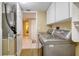 Bright laundry room with washer, dryer and storage at 1 John Anderson Dr # 1070, Ormond Beach, FL 32176