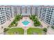 Aerial view showing the building's courtyard, pool, and landscaping at 1 John Anderson Dr # 1070, Ormond Beach, FL 32176