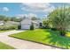 Single-story house with a two-car garage and well-maintained lawn at 3836 Long Grove Ln, Port Orange, FL 32129