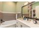 Elegant bathroom with a soaking tub, double vanity, and walk-in closet at 3836 Long Grove Ln, Port Orange, FL 32129