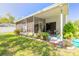 Spacious screened patio with lush landscaping and seating area at 3836 Long Grove Ln, Port Orange, FL 32129