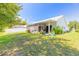 Relaxing backyard view, showcasing a screened patio and green lawn at 3836 Long Grove Ln, Port Orange, FL 32129