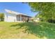 Landscaped backyard with a screened patio and large grassy area at 3836 Long Grove Ln, Port Orange, FL 32129