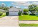Single-story house with a two-car garage and well-maintained lawn at 3836 Long Grove Ln, Port Orange, FL 32129