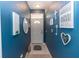 Bright blue entryway with mirror, wall decor, and tiled floor at 399 Foxhill Dr, Debary, FL 32713